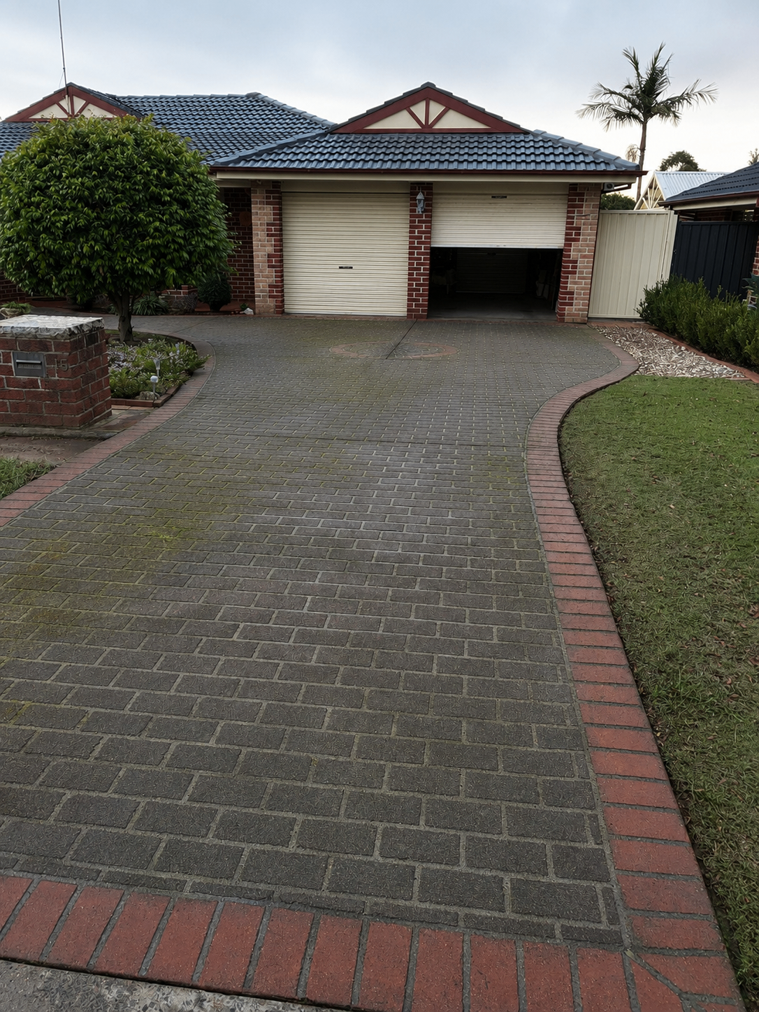 Before — Paver driveway before and after high-pressure cleaning